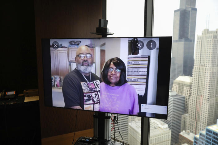 FILE - A monitor displays an image of Veldarin Jackson, Sr. and his mother, Janice Reed, who was one of the three senior victims who died in a Rogers Park building where residents complained of heat, at the office of attorney Larry R. Rogers, Jr., Tuesday, May 24, 2022, in Chicago. As heat waves fueled by climate change arrive earlier, grow more intense and last longer, people over 60 who are more vulnerable to high temperatures are increasingly at risk of dying from heat-related causes. (Jose M. Osorio/Chicago Tribune via AP, File)