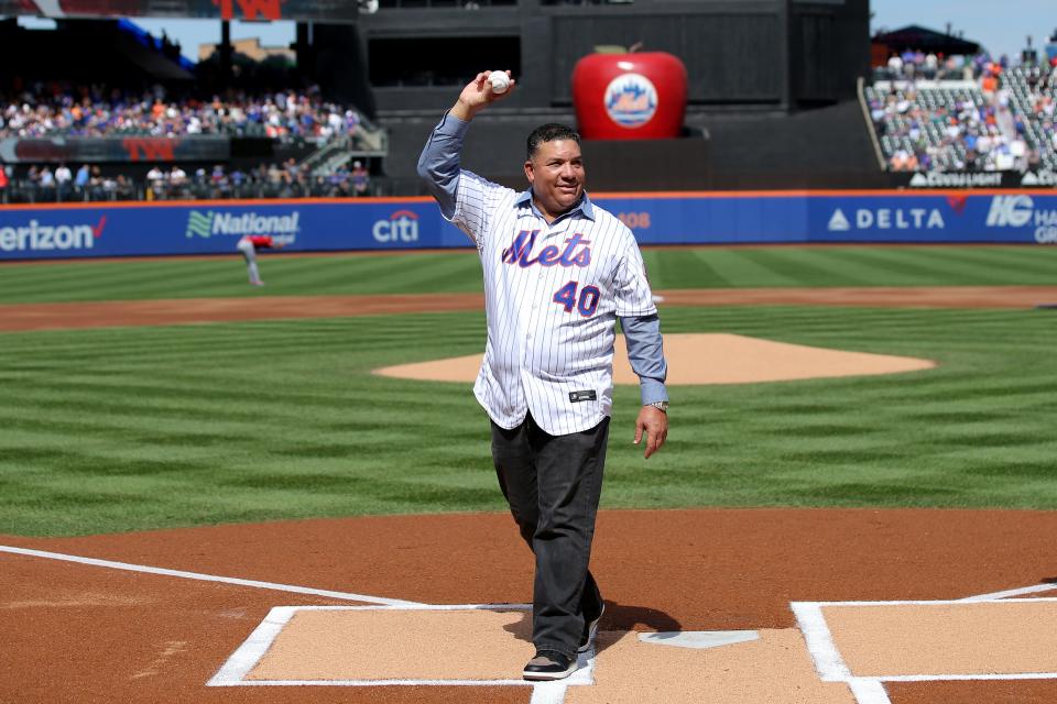 New York Mets former pitcher Bartolo Colon waves after throwing out a ceremonial first pitch before a game against the Cincinnati Reds at Citi Field. Colon today retired from baseball as a Met.