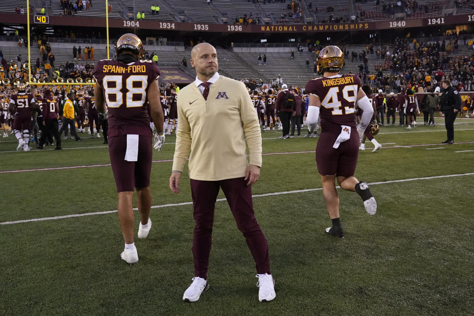 Minnesota head coach P. J. Fleck, center, stands on the field after an NCAA college football game against Illinois, Saturday, Nov. 4, 2023, in Minneapolis. (AP Photo/Abbie Parr)