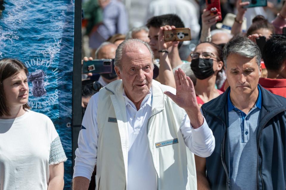 TOPSHOT - Spain's former King Juan Carlos I waves from his &quot;Bribon&quot; boat, as he attends the regatta of the InterRias trophy of 6M Spanish Cup, in the Galician town of Sanxenxo, northwestern Spain, on May 21, 2022. - Spain's former king returned to the country on May 19, 2022 for his first visit since he left nearly two years ago following a string of financial scandals. (Photo by Brais Lorenzo / AFP) (Photo by BRAIS LORENZO/AFP via Getty Images)
