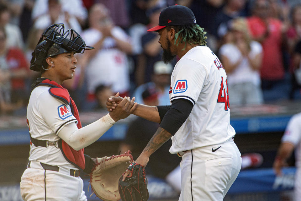Cleveland Guardians' Bo Naylor, left, congratulates closer Emmanuel Clase after the third out in the ninth inning of a baseball game against the San Francisco Giants in Cleveland, Saturday, July 6, 2024. (AP Photo/Phil Long)
