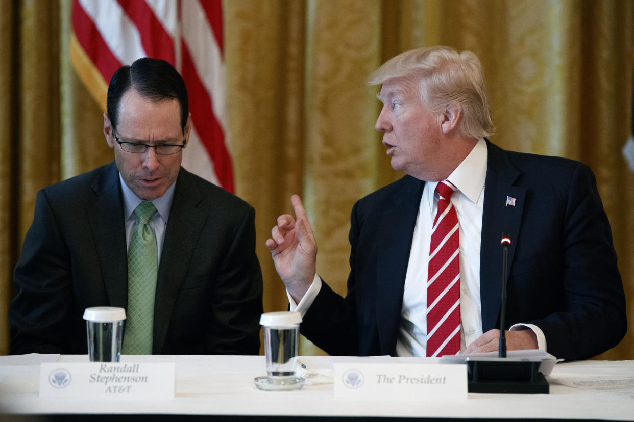 AT&T CEO Randall Stephenson, left, listens as President Donald Trump speaks during the “American Leadership in Emerging Technology” event in the East Room of the White House in Washington. (AP Photo/Evan Vucci, File)