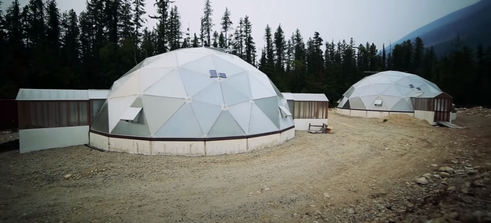 Two futuristic-looking dome greenhouses outside