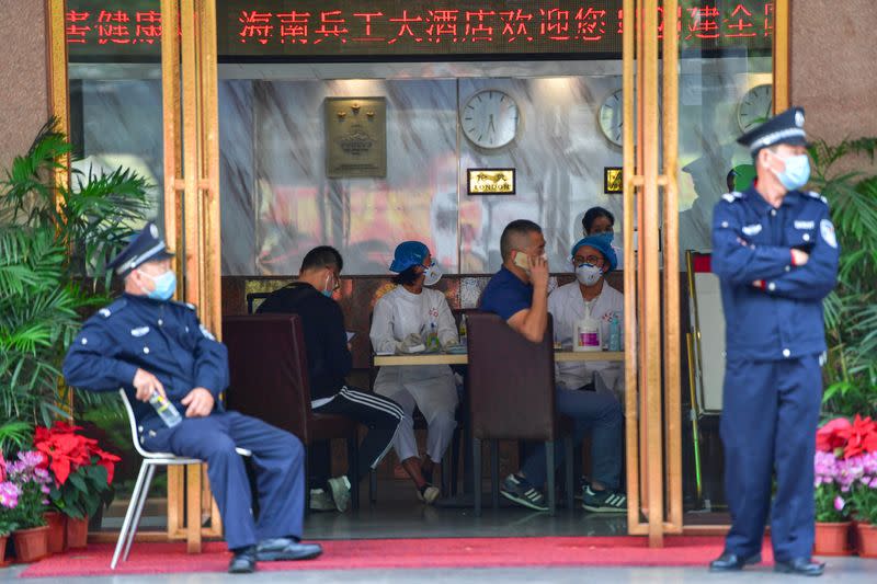 Medical staff are seen at a hotel lobby where tourists from Hubei province, the centre of the coronavirus outbreak, will have 14-day centralised medical observation, in Haikou, Hainan