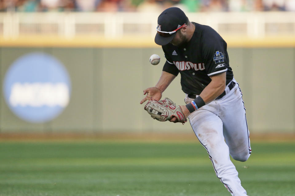 Louisville second baseman Justin Lavey bobbles a ball hit for a base hit by Vanderbilt's Austin Martin during the sixth inning of an NCAA College World Series baseball game in Omaha, Neb., Friday, June 21, 2019. (AP Photo/Nati Harnik)