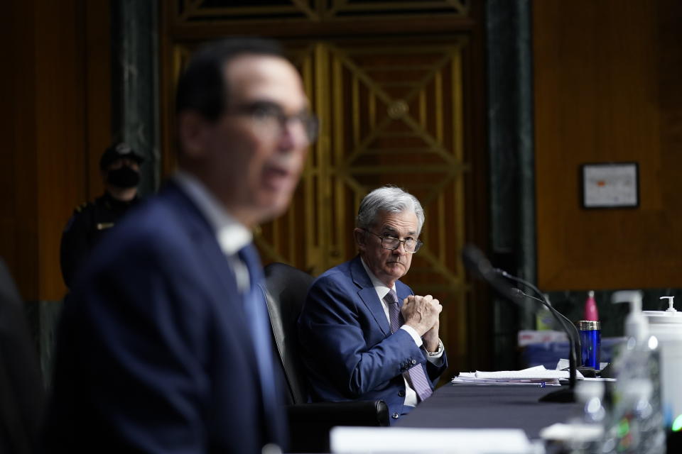 Chairman of the Federal Reserve Jerome Powell listens as Treasury Secretary Steven Mnuchin testifies during a Senate Banking Committee hearing on 'The Quarterly CARES Act Report to Congress' on Capitol Hill in Washington, Tuesday, Dec. 1, 2020. (AP Photo/Susan Walsh, Pool)