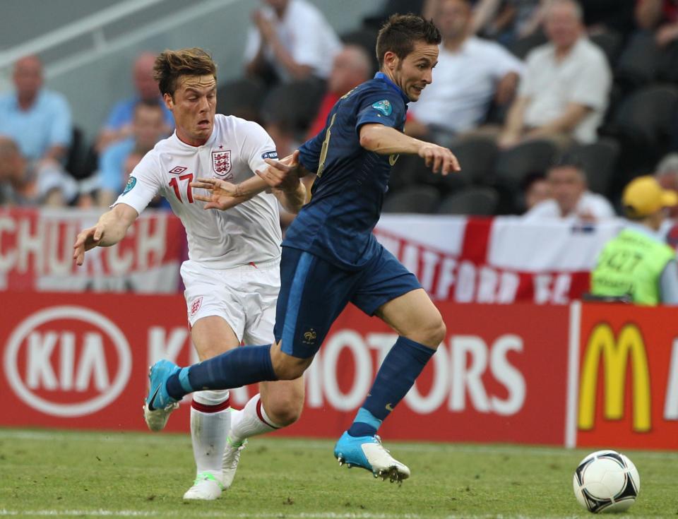 France's Yohan Cabaye skips over a tackle from Scott Parker of England.