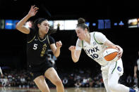 Minnesota Lynx forward Jessica Shepard (10) drives against Las Vegas Aces forward Dearica Hamby (5) during a WNBA basketball game in Las Vegas on Thursday, May 19, 2022. (Steve Marcus/Las Vegas Sun via AP)