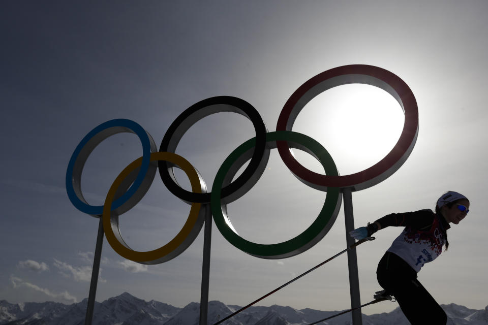 FILE - In this file photo dated Thursday, Feb. 20, 2014, a skier passes by the Olympic rings at the 2014 Winter Olympics, in Krasnaya Polyana, Russia. Overshadowed by the international crisis over Ukraine, Russia welcomes the sporting world back to Sochi this week for the Winter Paralympics that will be snubbed by some politicians and will struggle to match the successful Winter Olympics that ended less than two weeks ago in the Russian Black Sea resort. (AP Photo/Felipe Dana, FILE)