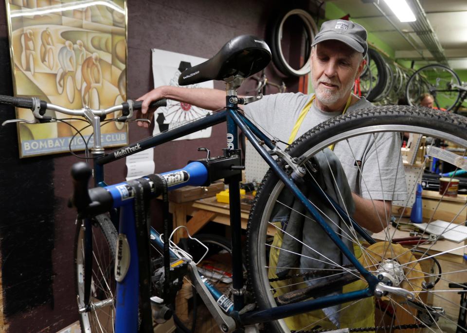 David Wright, of Cleveland, Wis., adjusts a brake on a bike during a work night at ReBike, Wednesday, May 10, 2023, in Sheboygan, Wis.
