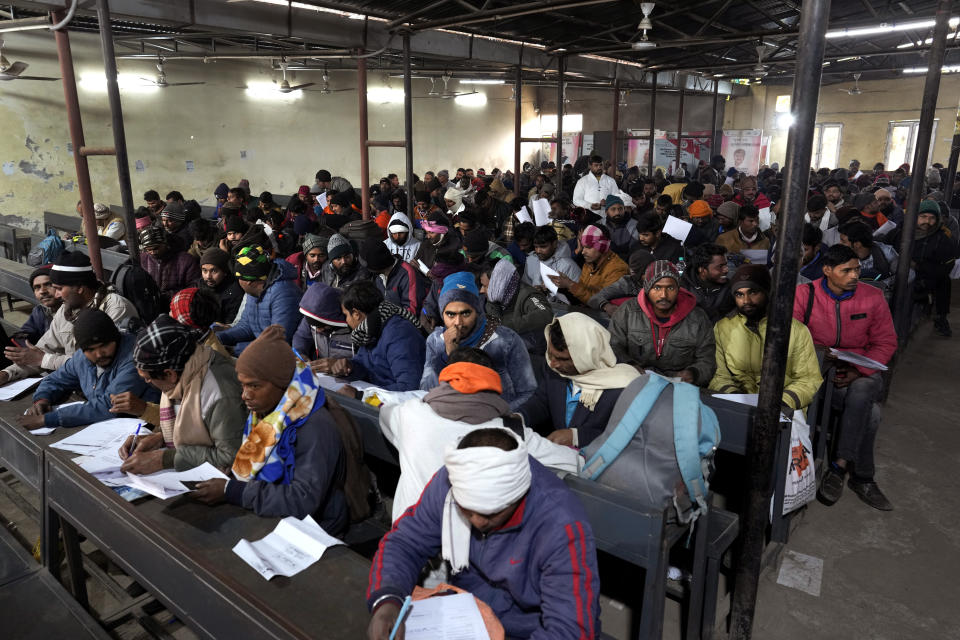 Indian workers aspiring to be hired for jobs in Israel fill their forms during a recruitment drive in Lucknow, India, Thursday, Jan. 25, 2024. (AP Photo/Rajesh Kumar Singh)