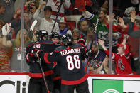 Carolina Hurricanes' Brendan Smith, center, celebrates his goal with teammates Sebastian Aho (20) and Teuvo Teravainen (86) during the second period of Game 2 of an NHL hockey Stanley Cup second-round playoff series in Raleigh, N.C., Friday, May 20, 2022. (AP Photo/Karl B DeBlaker)