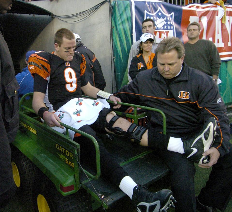 JANUARY 8, 2006: Carson Palmer leaves the field on a cart after being injured on the second offensive play of the game.