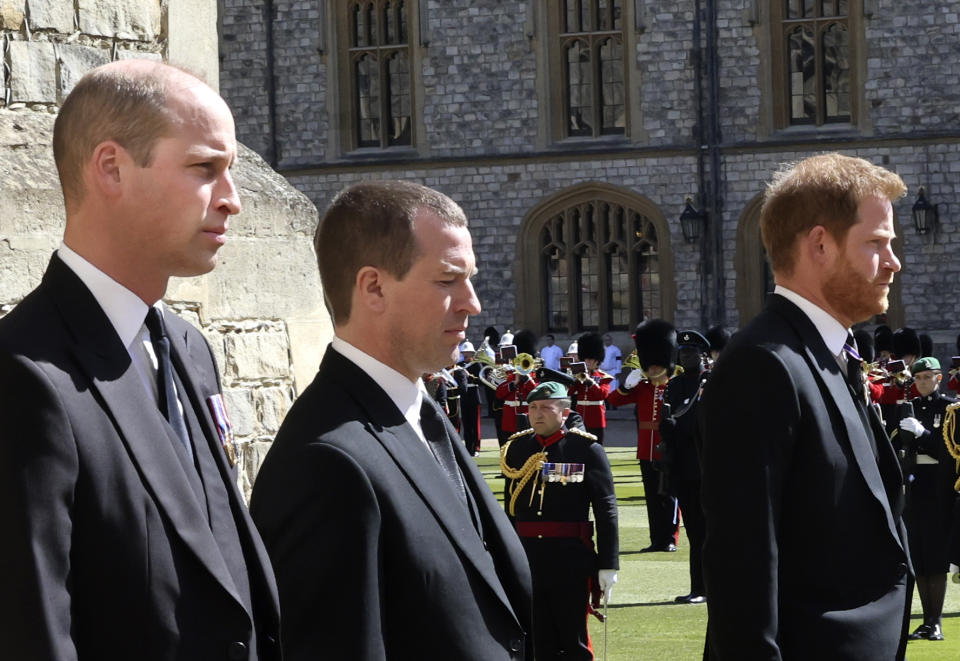 From left, Prince William, Peter Phillips and Prince Harry walk in a procession behind the coffin of Prince Philip, during the funeral of Britain's Prince Philip inside Windsor Castle in Windsor, England, Saturday, April 17, 2021. Prince Philip died April 9 at the age of 99 after 73 years of marriage to Britain's Queen Elizabeth II. (Chris Jackson/Pool via AP)