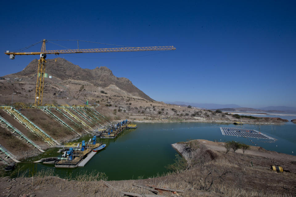 An island of solar panels floats in a pond at the Los Bronces mining plant, about 65 kilometers (approximately 40 miles) from Santiago, Chile, Thursday, March 14, 2019. The array floats in the middle of a pond that is used to contain the refuse from mining, known as tailings, and it is expected that the island's shadow will lower the water temperature and reduce evaporation by 80 percent. (AP Photo/Esteban Felix)