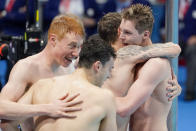 Britain's men's 4x200-meters relay team Tom Dean, James Guy, Matthew Richards and Duncan Scott celebrare after winning the gold medal at the 2020 Summer Olympics, Wednesday, July 28, 2021, in Tokyo, Japan.(AP Photo/Charlie Riedel)