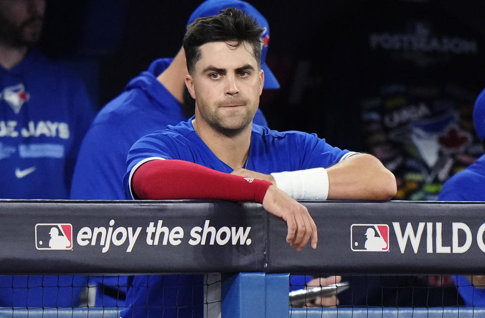Toronto Blue Jays' Whit Merrifield watches from the dugout during the fifth inning of Game 2 of a baseball AL wild-card playoff series Saturday, Oct. 8, 2022, in Toronto. Merrifield was hit by a Seattle Mariners pitch in the inning. (Frank Gunn/The Canadian Press via AP)