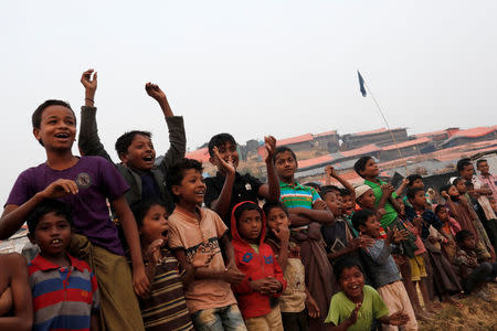 Rohingya refugee children react as they watch a football match in Palong Khali camp, near Cox's Bazar, Bangladesh January 14, 2018. REUTERS/Tyrone Siu