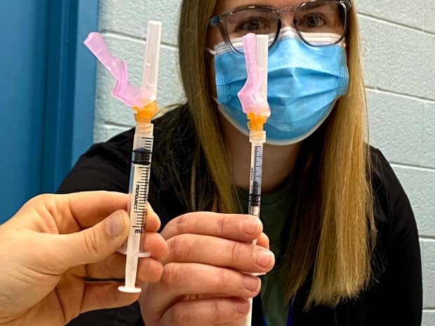 A York Region public health staffer demonstrates the differences between syringes. The syringe on the right is better at drawing the pesky final vaccine dose from a vial. It's where the majority of its wastage comes from.