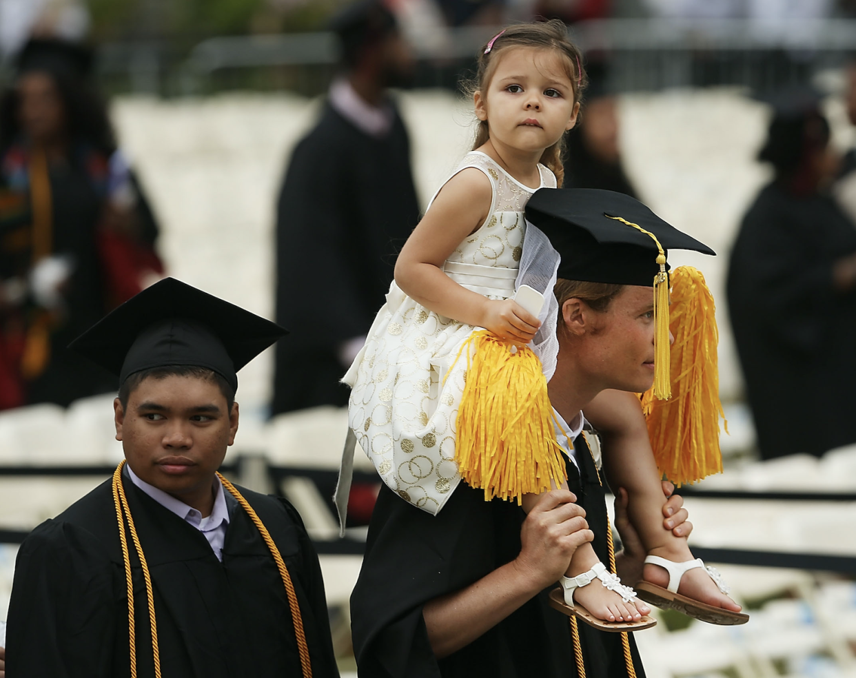 Graduating student Kaspar Wittlinger holds his daughter Isabela during ceremonies for commencement exercises at City College on June 3, 2016 in New York City. (Photo: Spencer Platt/Getty Images) 