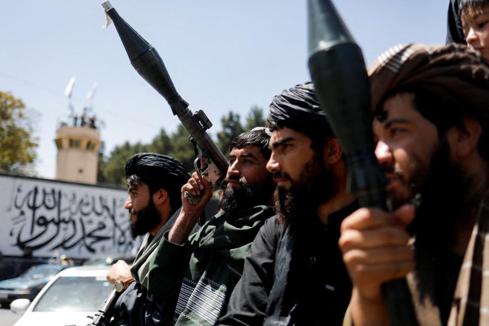 Taliban soldiers celebrate on the second anniversary of the fall of Kabul on a street near the US embassy in Kabul, Afghanistan, August 15, 2023. Former Canadian military interpreters and their loved ones are still trying to flee them.  REUTERS/Ali Khara     TPX IMAGES OF THE DAY