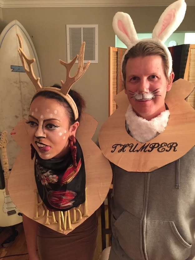 Two people dressed as animal heads mounted on a wall