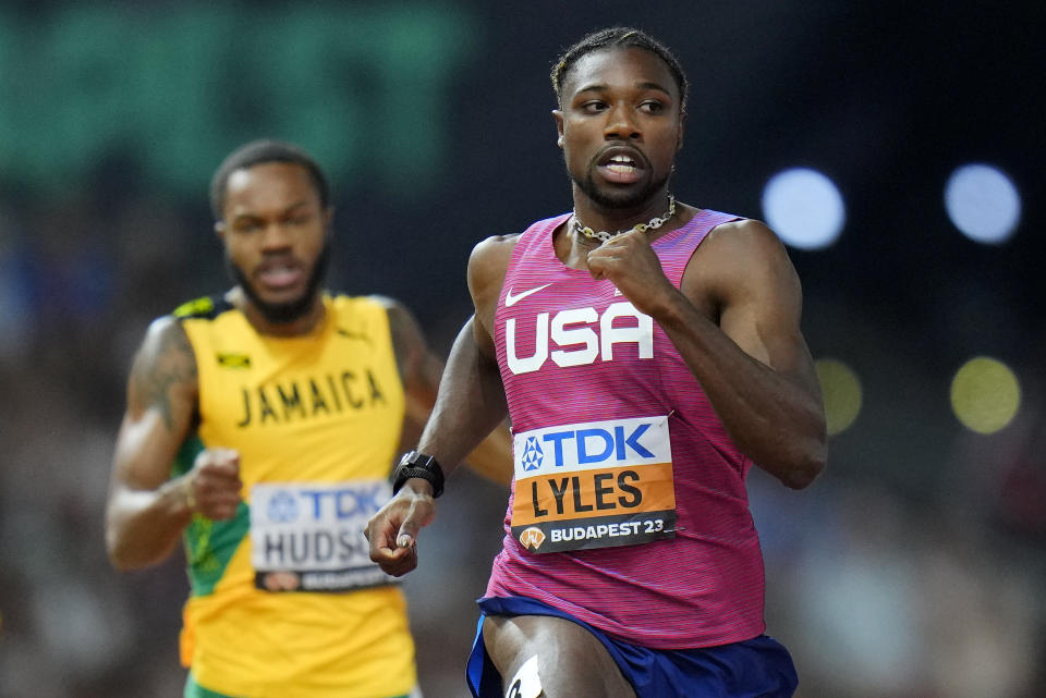 Noah Lyles, of the United States races ahead of Andrew Hudson, of Jamaica in a Men's 200-meters semifinal during the World Athletics Championships in Budapest, Hungary, Thursday, Aug. 24, 2023. (AP Photo/Petr David Josek)
