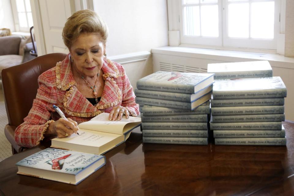 In this Wednesday, April 3 2013 photo, author Mary Higgins Clark sign copies of her latest book "Daddy's Gone A Hunting" at the Simon & Schuster office in New York. Her current book is a vintage Clark thriller featuring women in distress, mysterious pasts and secret identities. It's about a deadly explosion that destroys a family furniture business in Long Island City. (AP Photo/Mary Altaffer)