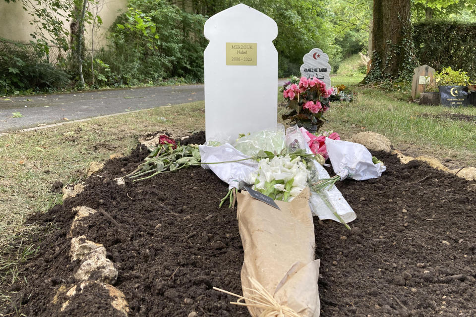 Flowers lay at the tomb of Nahel Merzouk Wednesday, July 5, 2023 in a cemetery in Nanterre, a Paris suburb. Video of the June 27, 2023 killing showed two police officers at the window of the car driven by Nahel, one with his gun pointed at the driver. As the teenager pulled forward, the officer fired once through the windshield. Nahel's death caused five nights of unrest in France. (AP Photo/Cara Anna)