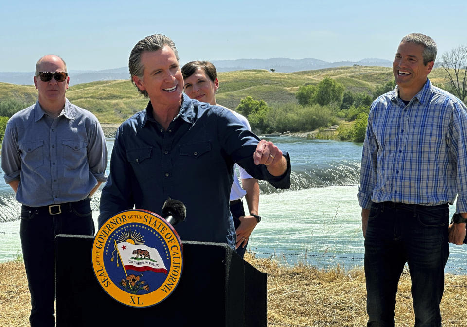 California Gov. Gavin Newsom speaks during a news conference in front of the Daguerre Point Dam on Tuesday, May 16, 2023, in Marysville, Calif. Local, state and federal officials plan to build a channel around the dam so threatened species of fish can access more habitat. (AP Photo/Adam Beam)
