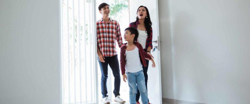 family asian entering their new home. buying new house concept