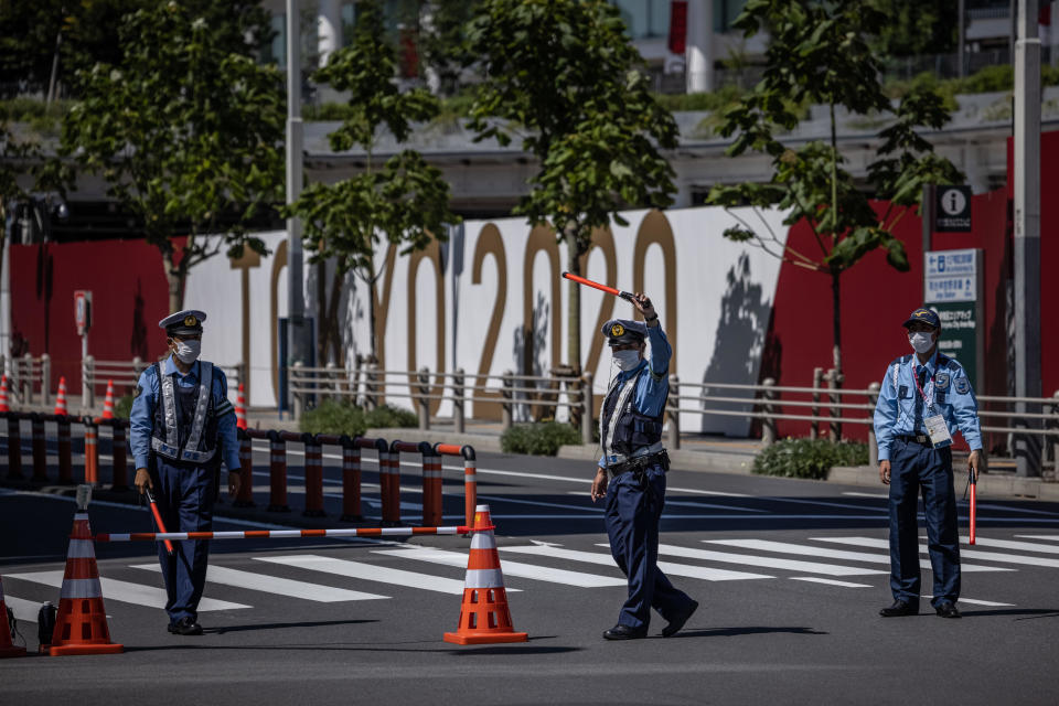 Police officers guard a road next to the Tokyo Olympic stadium, July 21, 2021, in Tokyo, Japan. / Credit: Carl Court/Getty