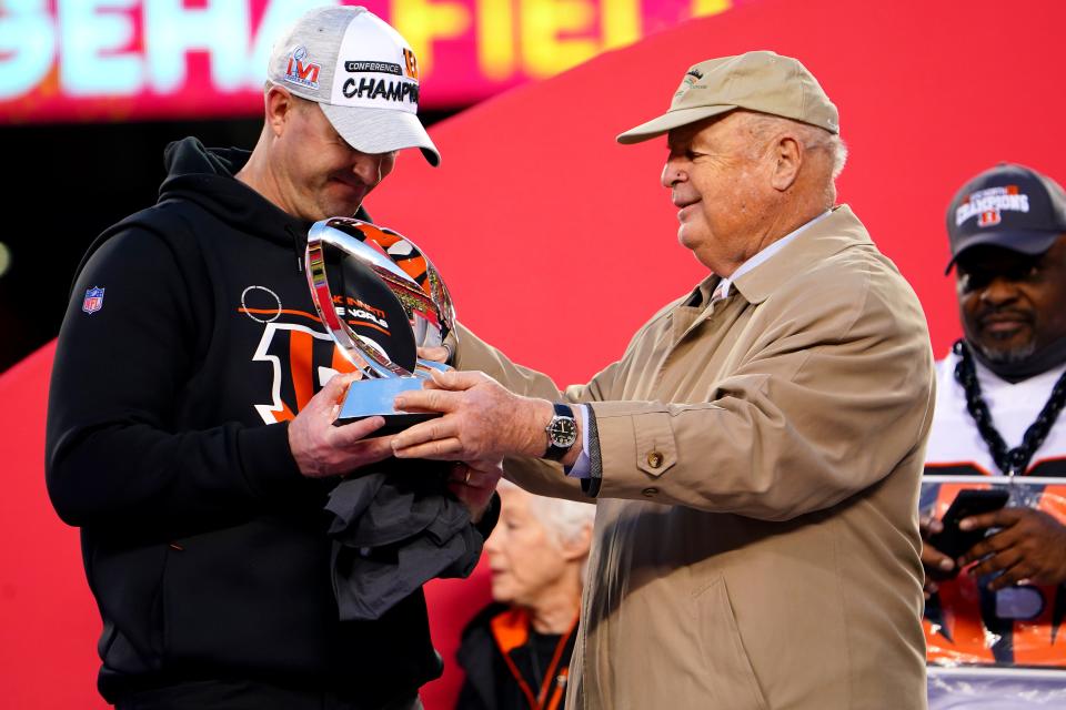 Cincinnati Bengals President Mike Brown hands head coach Zac Taylor the AFC championship trophy at the conclusion of the AFC championship game, Sunday, Jan. 30, 2022, in Kansas City, Mo.