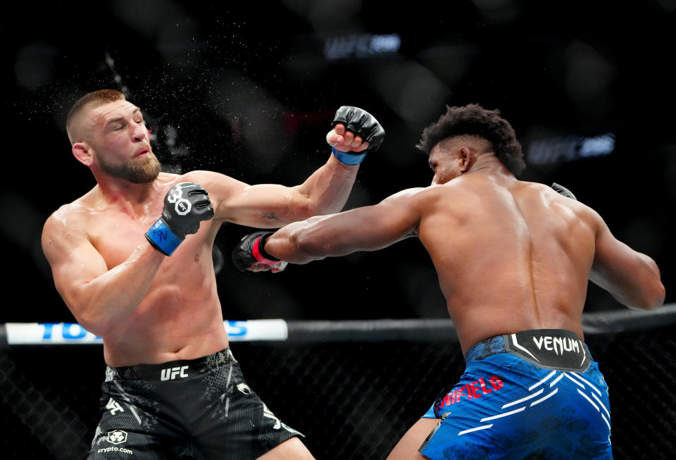Dec 16, 2023; Las Vegas, Nevada, USA; Alonzo Menifield (red gloves) fights Dustin Jacoby (blue gloves) during UFC 296 at T-Mobile Arena. Mandatory Credit: Stephen R. Sylvanie-USA TODAY Sports