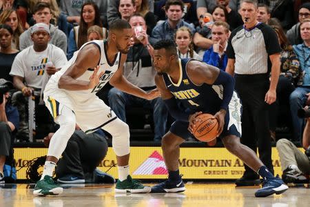 Oct 18, 2017; Salt Lake City, UT, USA; Denver Nuggets forward Paul Millsap (4) tries to get past Utah Jazz forward Derrick Favors (15) and to the basket during the fourth quarter at Vivint Smart Home Arena. Utah Jazz won the game 106-96. Mandatory Credit: Chris Nicoll-USA TODAY Sports