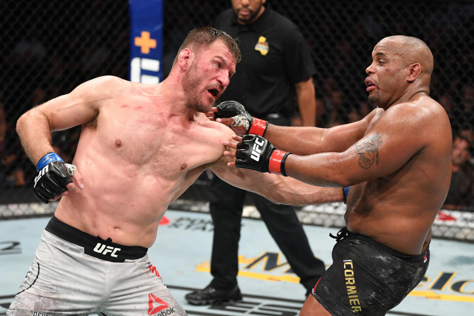 ANAHEIM, CALIFORNIA - AUGUST 17:  (L-R) Stipe Miocic punches Daniel Cormier in their heavyweight championship bout during the UFC 241 event at the Honda Center on August 17, 2019 in Anaheim, California. (Photo by Josh Hedges/Zuffa LLC/Zuffa LLC via Getty Images)