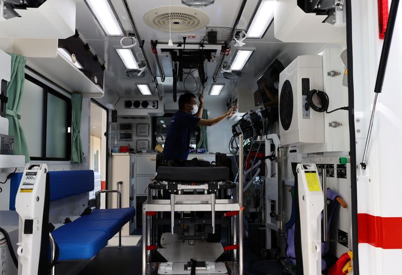Doctor Shoji Yokobori checks the devices of an ambulance at the hospital in Tokyo