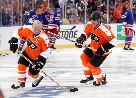 Philadelphia Flyers Bob Clarke (L) skates next to Eric Lindros before the start of the Flyers alumni versus the New York Rangers alumni during the first period of the 2012 NHL Winter Classic Alumni ice hockey game in Philadelphia, Pennsylvania December 31, 2011. REUTERS/Tim Shaffer