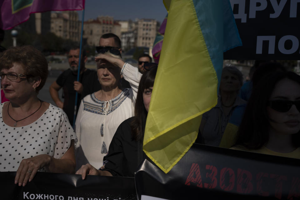 A woman cries at a protest calling for the release of Ukrainian soldiers captured by Russians at the Independence Square in Kyiv, Ukraine, Sunday, Aug. 27, 2023. The protest marks five hundred days since the soldiers were captured in the besieged city of Mariupol. (AP Photo/Bram Janssen)