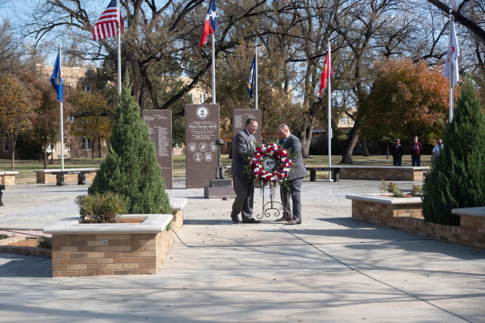Dr. Rodney Gonzalez, the director of the Amarillo VA, and Walter Wendler, president of WT, lay a wreath down at the base of the WT Veteran Memorial at a community veterans ceremony Friday at West Texas A&M University in Canyon.