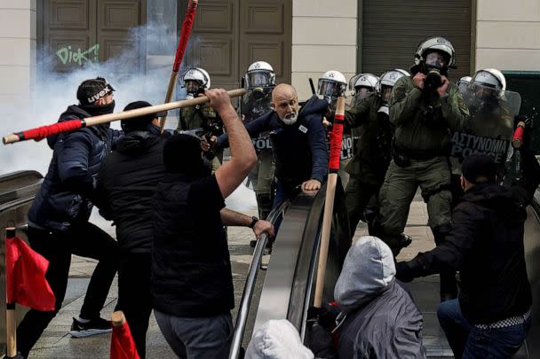 PHOTO: Protesters clash with riot police as an employee of the Athens Metro tries to intervene at the entrance of a station, during a demonstration following the collision of two trains, near the city of Larissa, in Athens, Greece, March 5, 2023. (Alkis Konstantinidis/Reuters)