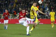 <p>United’s Phil Jones clears the danger </p>