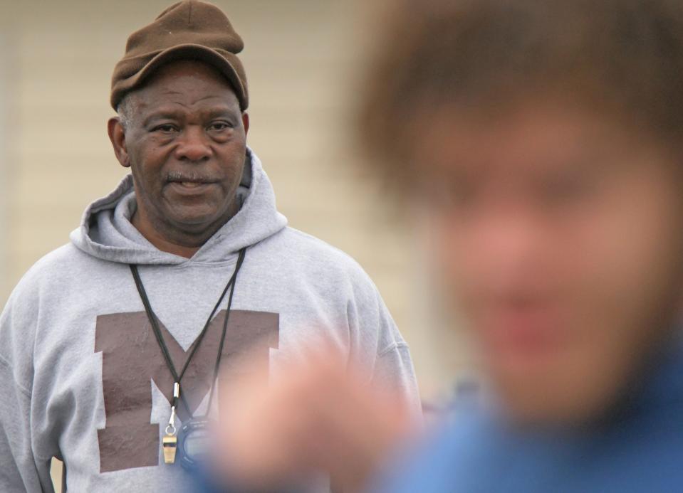 Tygers track coach Tyree Shine watches over practice Thursday afternoon.