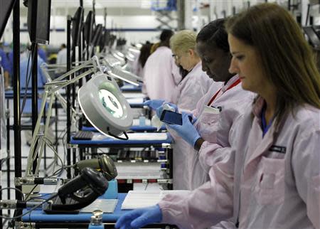 Workers assemble Motorola phones at the Flextronics plant that will be building the new Motorola smart phone "MotoX" in Fort Worth, Texas September 10, 2013. REUTERS/Mike Stone