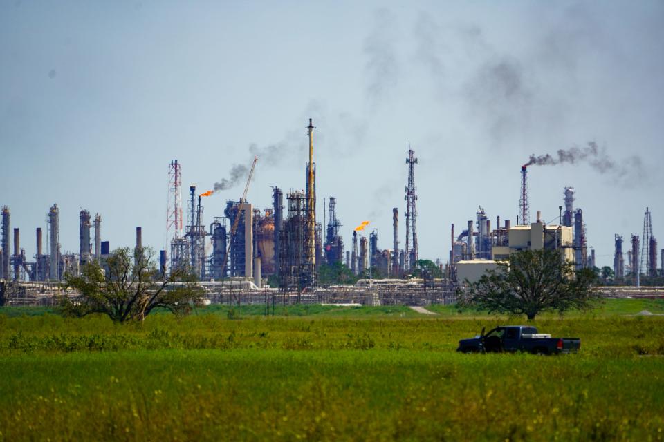 Pollution from refineries near the Mississippi River outside New Orleans, Louisiana, lofts into the air.