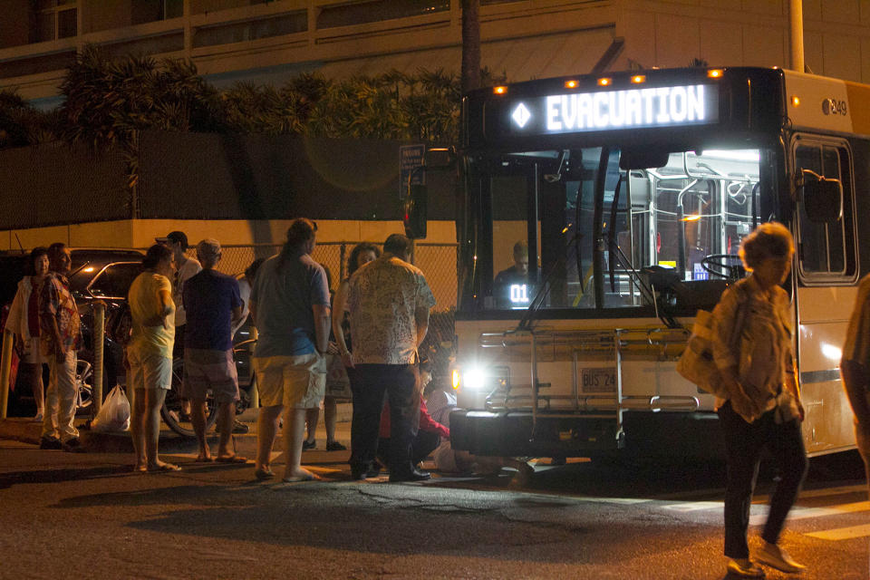 <p>An evacuation bus takes residents of the Marco Polo building to a nearby shelter after a deadly fire at the building, Friday, July 14, 2017, in Honolulu. (Photo: Marco Garcia/AP) </p>