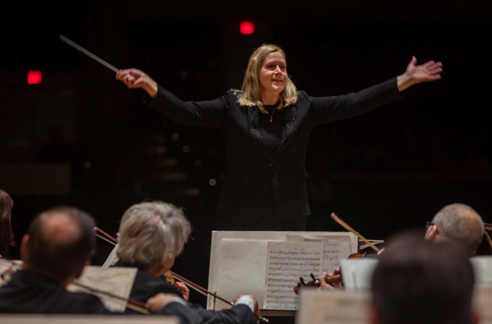 Music Director & Conductor of the Warren Symphony Orchestra, Gina Provenzano, raises her arms during a performance in front of middle school and elementary students inside the Warren Woods Community Auditorium at Warren Woods Middle School in Warren on Oct. 27, 2022. 