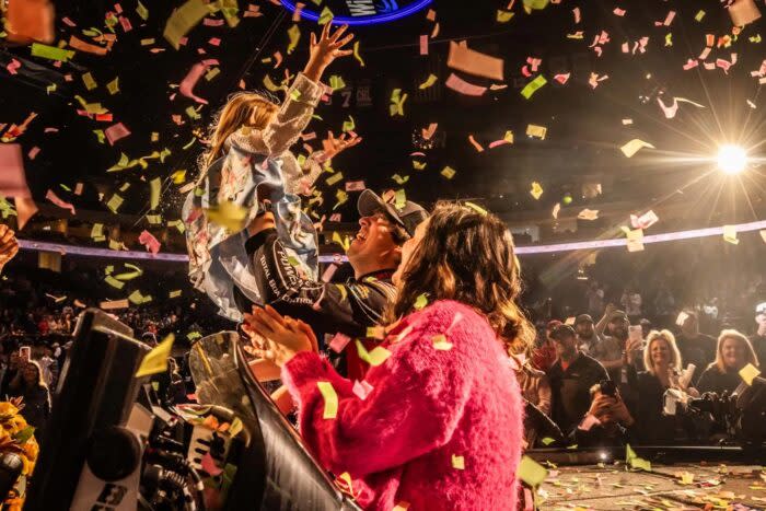 Justin Hamner Celebrates Bassmaster Classic win with wife and daugher.