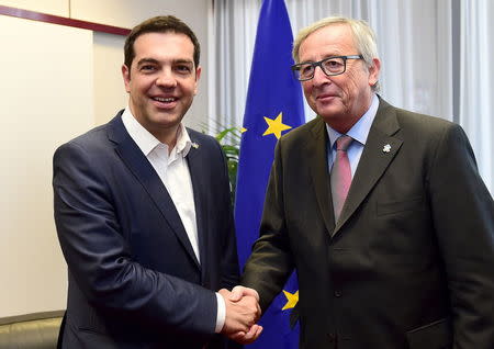 Greek Prime Minister Alexis Tsipras poses with European Commission President Jean-Claude Juncker (R) ahead of a meeting at the EU Council in Brussels, Belgium, June 11, 2015. REUTERS/Emmanuel Dunand/Pool