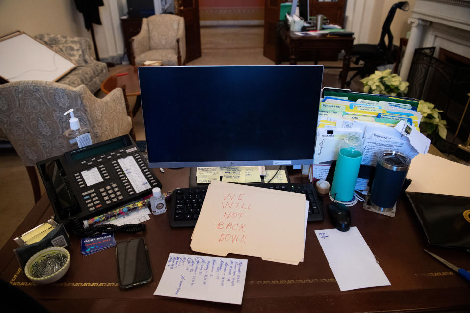 A folder on which a Trump supporter has written “We will not back down” is seen on Nancy Pelosi’s desk after the Capitol insurrection.